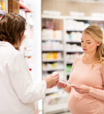 happy-pregnant-woman-and-apothecary-at-pharmacy-ppgcqph.jpg